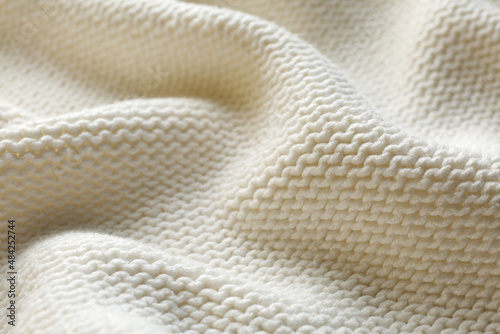 Fotografie Beautiful white knitted fabric as background, closeup