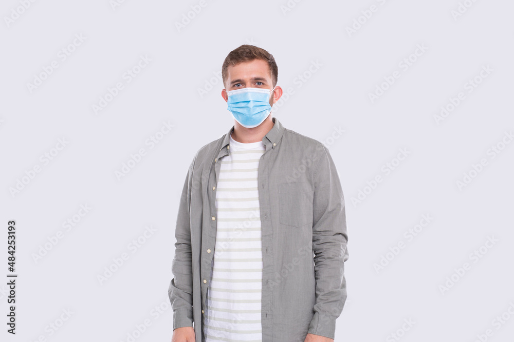 Man Wearing Medical Mask Isolated. Man In Green Shirt with Medical Mask. Health, Virus, Medical Concept Man Wearing Medical Mask Isolated. Man In Green Shirt with Medical Mask. Health, Virus, Medical Concept