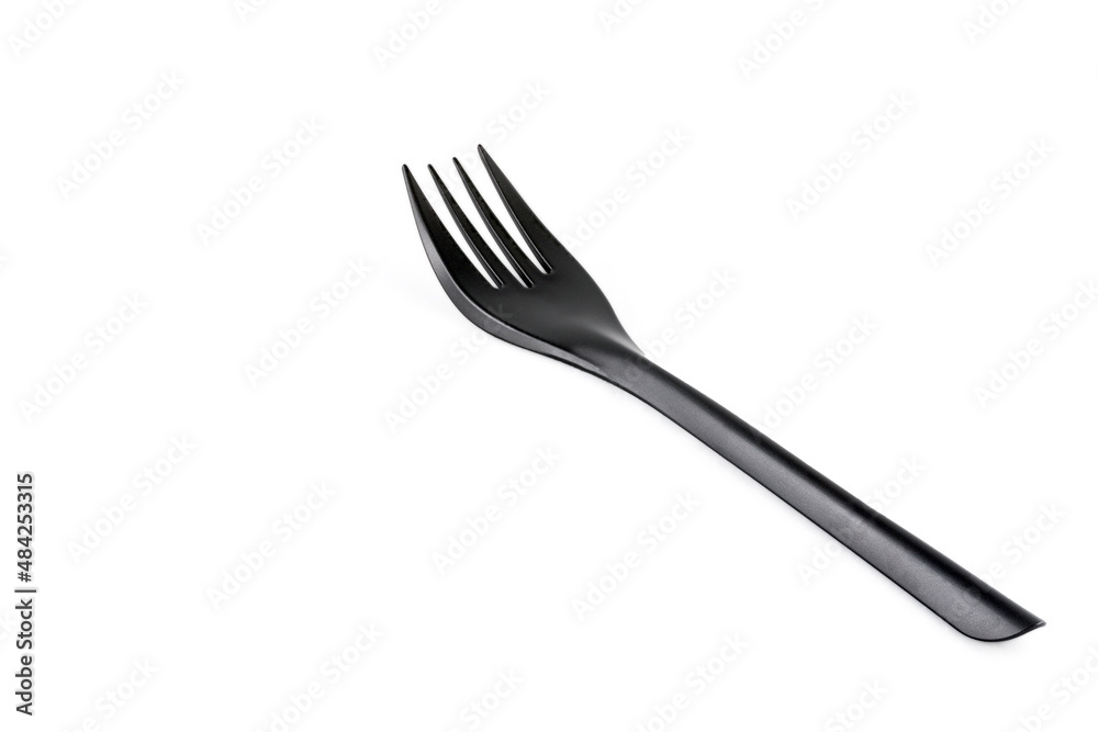 Disposable black plastic fork isolated on white background. Close-up. Full depth of field. Disposable black plastic fork isolated on white background. Close-up. Full depth of field.