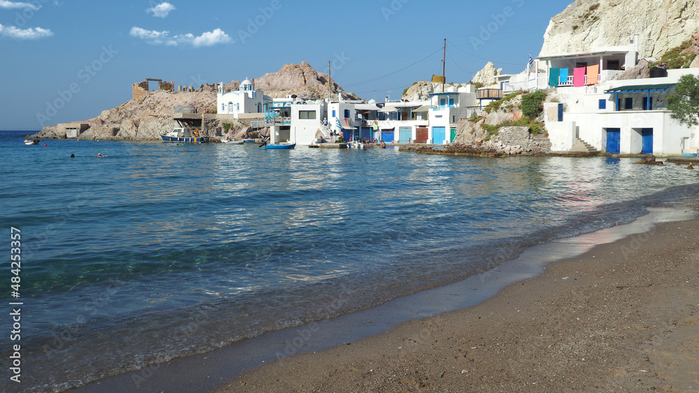 Beautiful fishermen seaside village and small sandy beach of Firopotamos with colourful boat houses called 