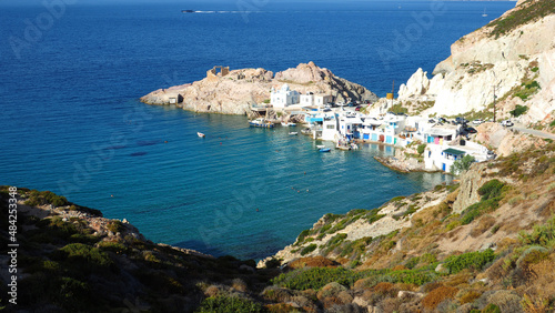 Beautiful fishermen seaside village and small sandy beach of Firopotamos with colourful boat houses called "Syrmata", Milos island, Cyclades, Greece