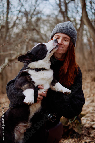 young woman hugging her dog