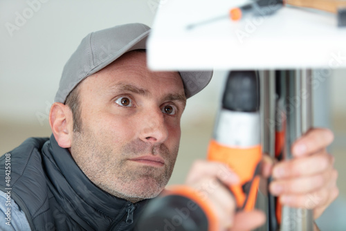 portrait of a handyman constructing a chair photo