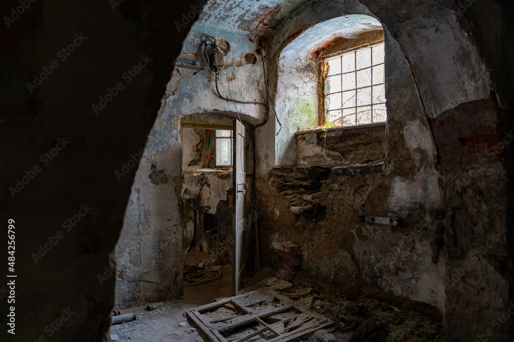 Basement of an abandoned building with damaged walls and interior in bad condition. Old ruin with paint peeling off. Eroded dangerous house with dirt on the floors. Basement of an abandoned building with damaged walls and interior in bad condition. Old ruin with paint peeling off. Eroded dangerous house with dirt on the floors.
