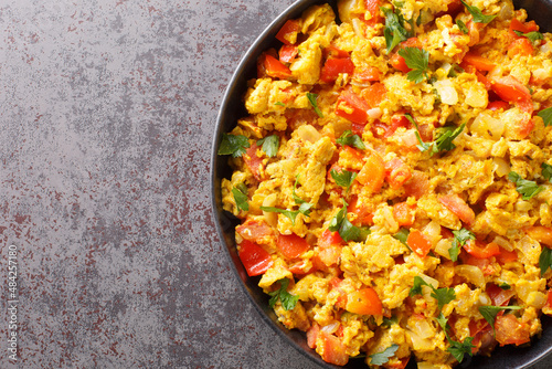 Perfect Egg Bhurji Spiced Indian Scrambled Eggs closeup in the plate on the table. Horizontal top view from above