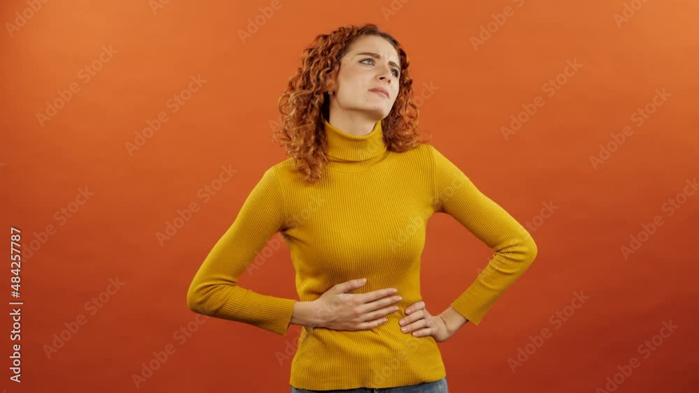 Vidéo Stock Attractive redhaired caucasian girl in an orange jumper