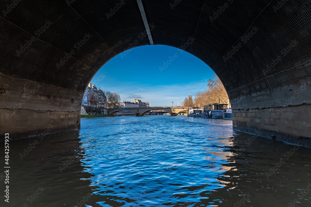 Paris, ile Saint-Louis, view under the arch of the pont Marie, with the Louis-Philippe bridge in background 
