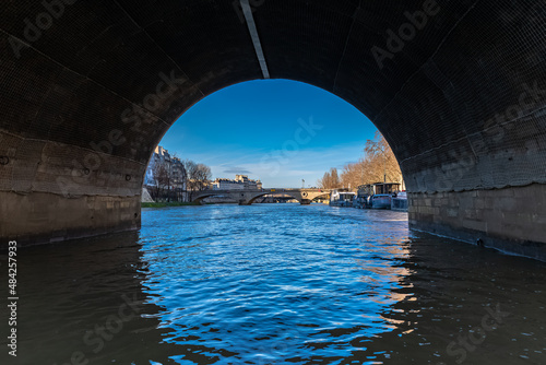 Paris, ile Saint-Louis, view under the arch of the pont Marie, with the Louis-Philippe bridge in background 