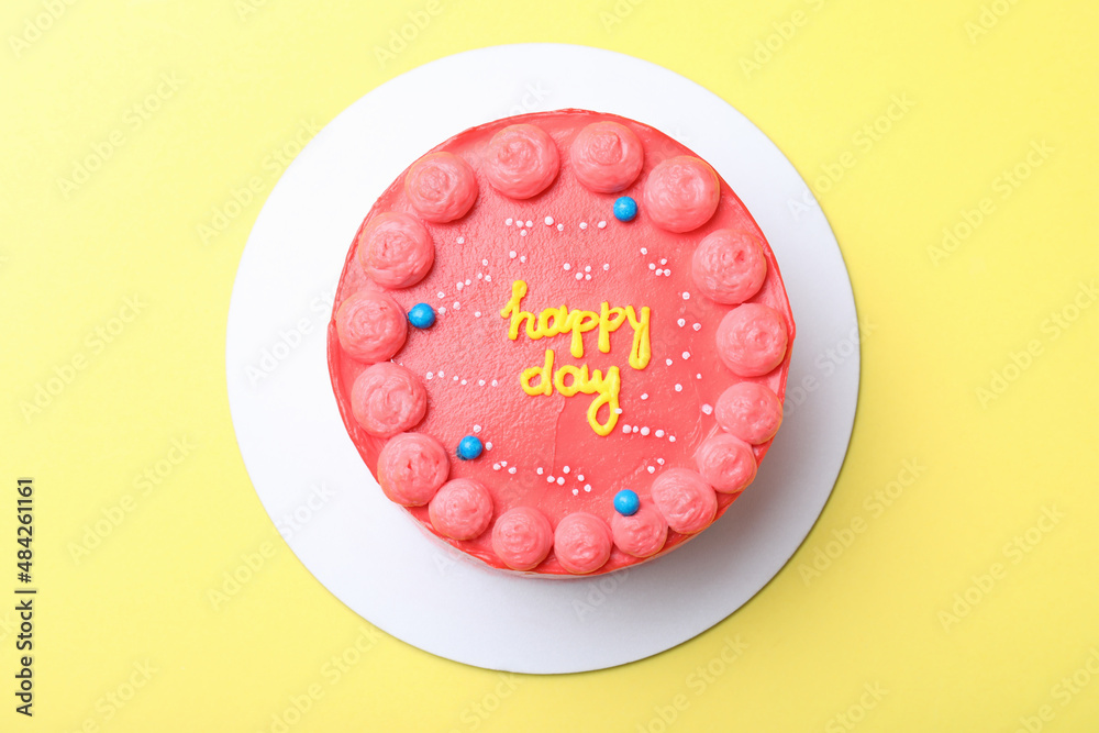 Cute bento cake with tasty cream on yellow background, top view Cute bento cake with tasty cream on yellow background, top view