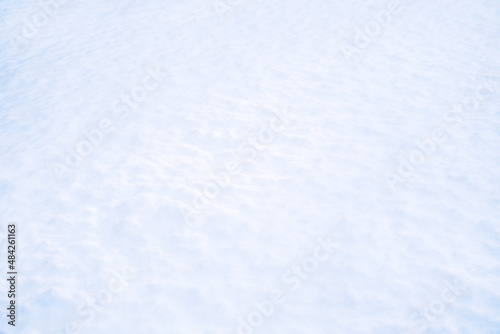 Snow surface close-up. Winter sunny day, frosty mood. Natural texture background. Copy space, place for text, top view