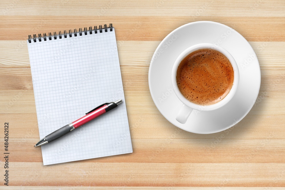 Paper with a cup of coffee, product or business review of the recent year Paper with a cup of coffee, product or business review of the recent year