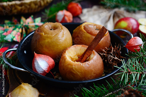 Baked apples with cinnamon sticks. Healthy homemade breakfast concept.