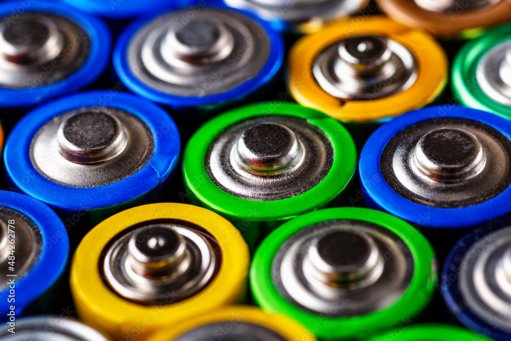 Energy abstract background of colorful batteries.Used batteries from different manufacturers, waste, collection and recycling,Alkaline battery aa size.Concept background of colorful batteries Energy abstract background of colorful batteries.Used batteries from different manufacturers, waste, collection and recycling,Alkaline battery aa size.Concept background of colorful batteries