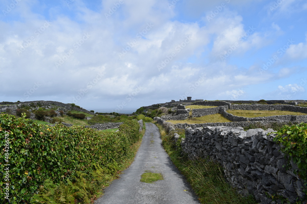 Road among courtyards in Irealnd island of Inisheer. Sunny summer day
