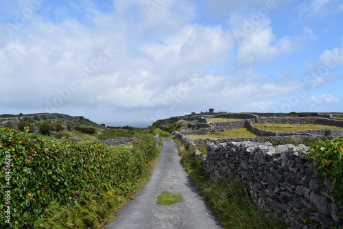 Road among courtyards in Irealnd island of Inisheer. Sunny summer day