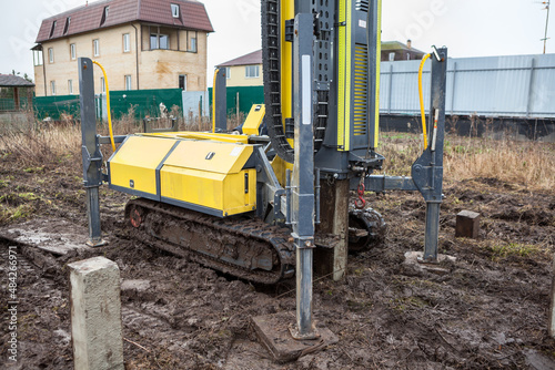 Crawler mounted piling rig in work, conctere pile foundation for frame house