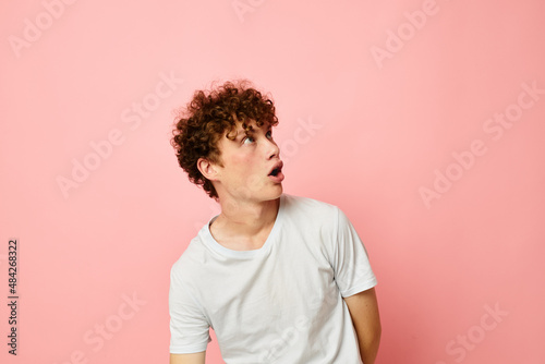 portrait of a young curly man summer clothes white tshirt posing Lifestyle unaltered