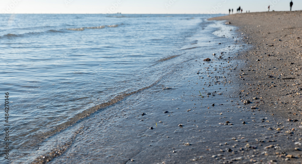 sandy beach against a clear sky and people in the background sandy beach against a clear sky and people in the background