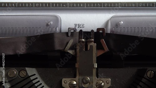 Typing word Free on a vintage typewriter. Close up. photo