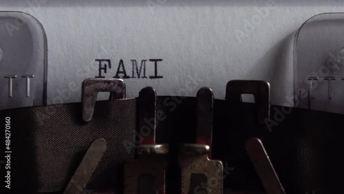 Typing word Family on an old typewriter. Close up. photo