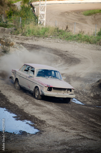 derelict car racing on dirt road