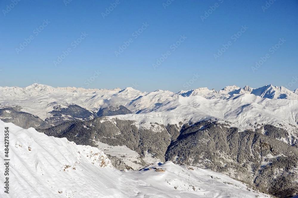Snowcapped mountains on sunny day with blue sky