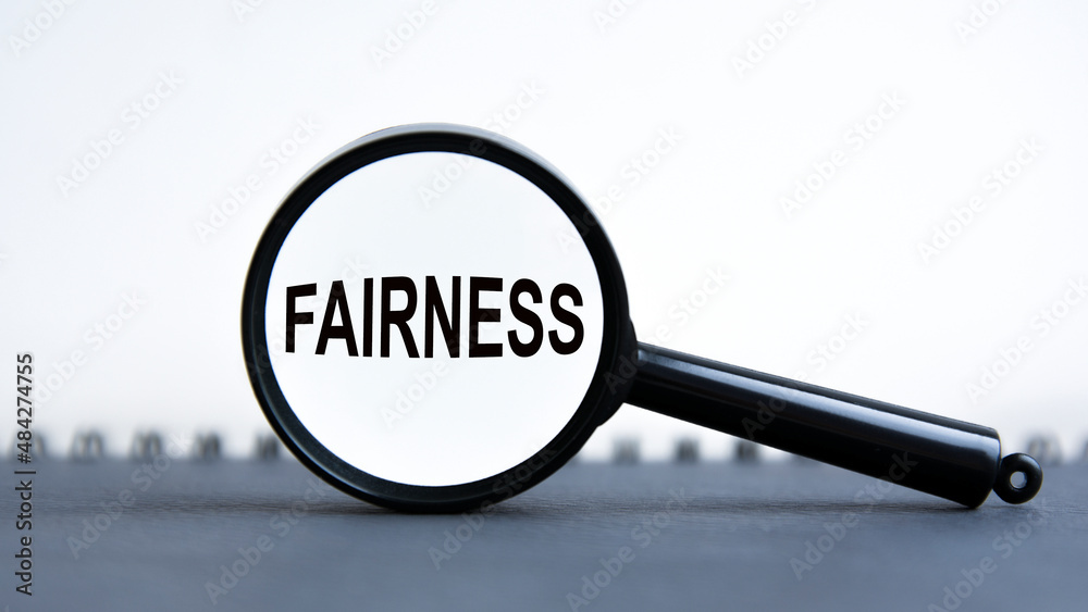 magnifying glass with the text Fairness, business concept