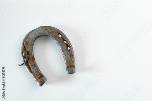 Old rusty grunge horseshoe isolated on white background with copy space. Top angle view.