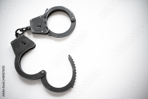 Fotografia, Obraz Open metal handcuffs on white isolate