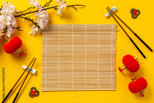 Chinese New Year tabble place setting with golden chopsticks photo