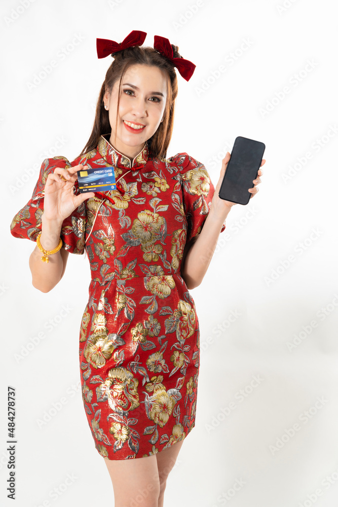 Happy chinese new year. excited young Woman showing blank smart phone screen, with credit card, mobile smart phone shopping online technology concept on white isolated background Happy chinese new year. excited young Woman showing blank smart phone screen, with credit card, mobile smart phone shopping online technology concept on white isolated background