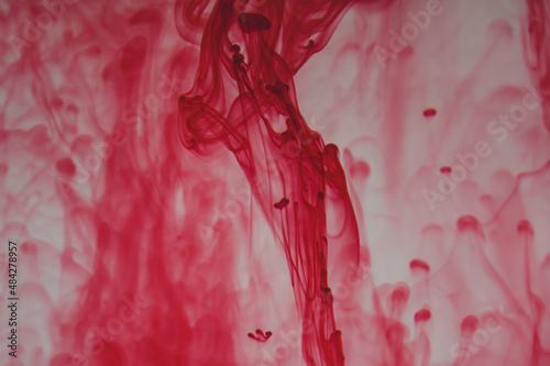 Red ink in the water abstract background. swirls of paint in liquid