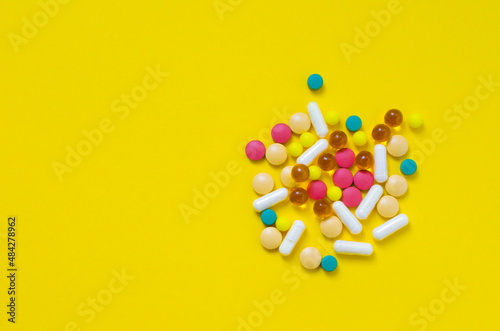 a lot of medical drugs on a yellow background flatlay