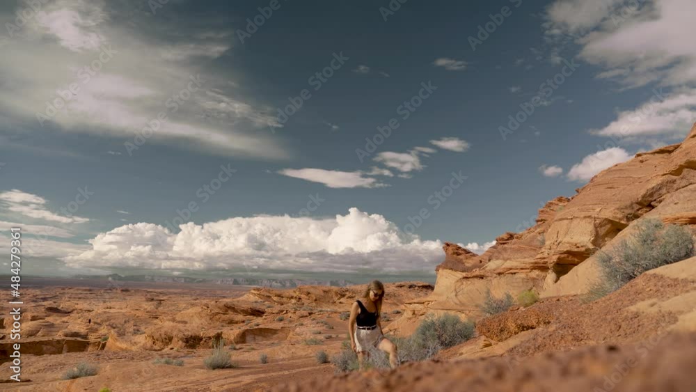 Young female adult hiker on a trail among the sandstone cliffs in Utah, USA. Cosmic landscape, adventure and travel concept. Young female adult hiker on a trail among the sandstone cliffs in Utah, USA. Cosmic landscape, adventure and travel concept.
