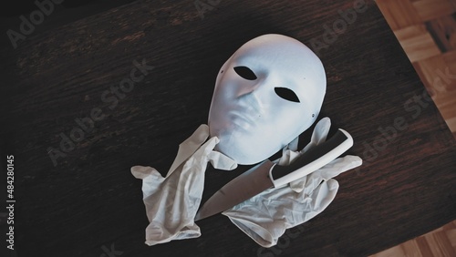 Serial Killer White Face Mask Latex Gloves and Kitchen Knife photo