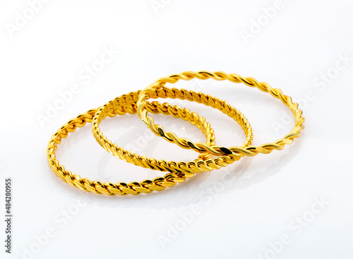 Gold jewelry. Gold bangle on background
