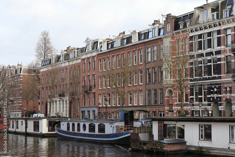Naklejka premium Amsterdam Van Lennepkade Canal View with House Boats and Traditional House Facades, Netherlands