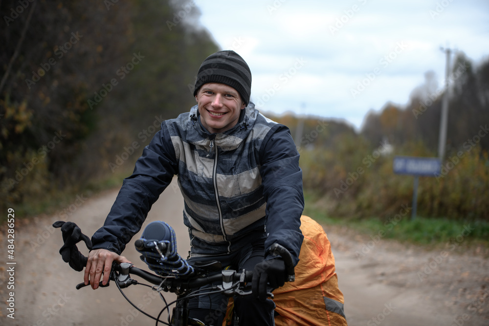 Fototapeta premium Russian bicyclist in the autumn forest, Moscow Region