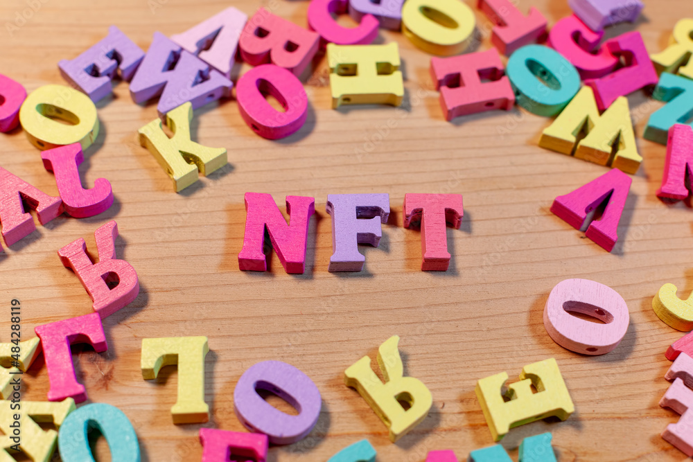 Fototapeta premium nft letters on light wooden background