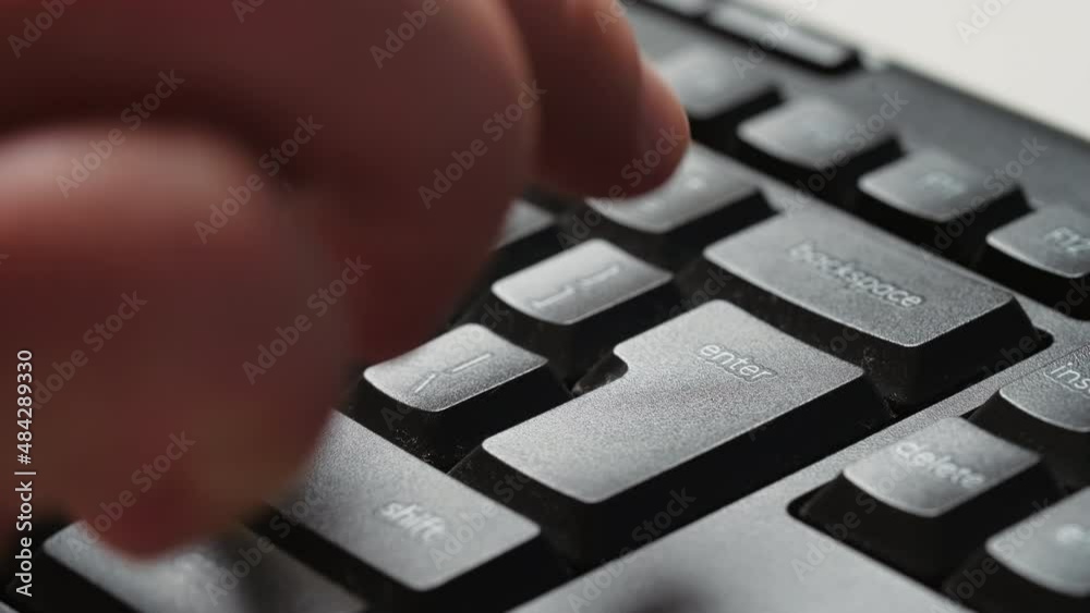 The man hesitates before press the key Enter on a desktop pc keyboard. Enter key mean digital confirmation, sending message. Detail of Enter button.