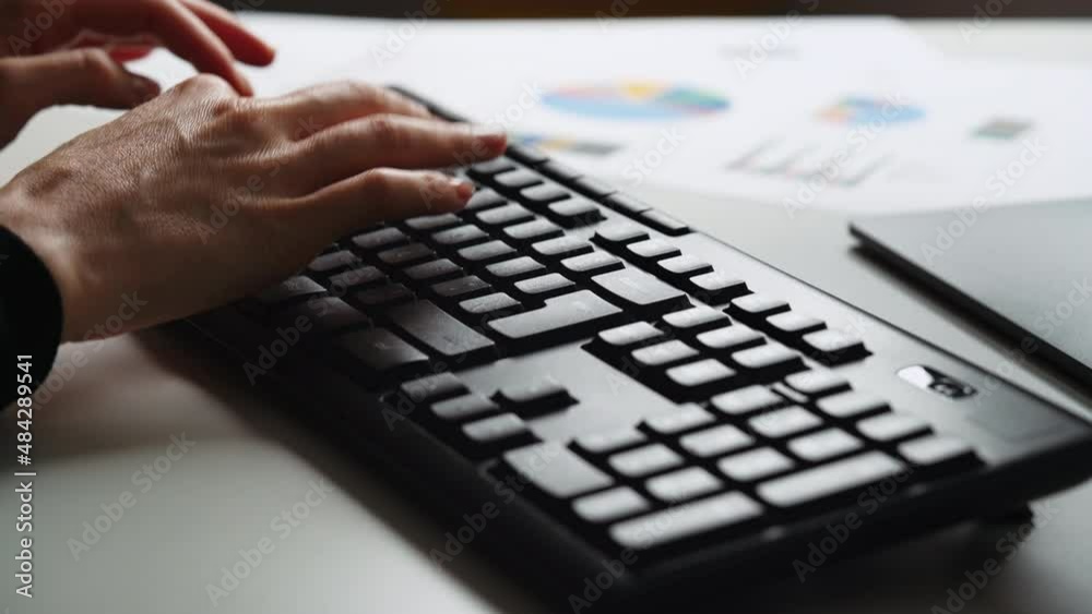 Business woman working late at office at computer typing on keyboard. Business financial accounting concept. Female using computer for financial reports, working late overtime Business woman working late at office at computer typing on keyboard. Business financial accounting concept. Female using computer for financial reports, working late overtime