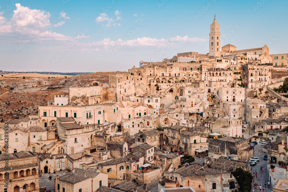 View of the Sassi di Matera from the Belvedere di San Pietro Barisano, blue sky with clouds