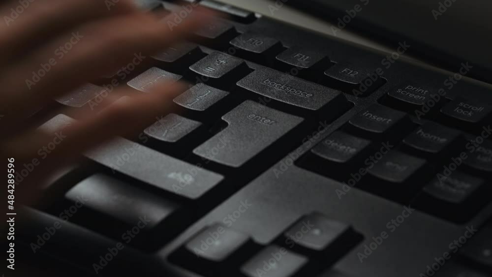Woman using computer, typing on keyboard, hitting the enter key on a desktop pc keyboard. Enter key mean digital confirmation, sending message. Detail of Enter button.