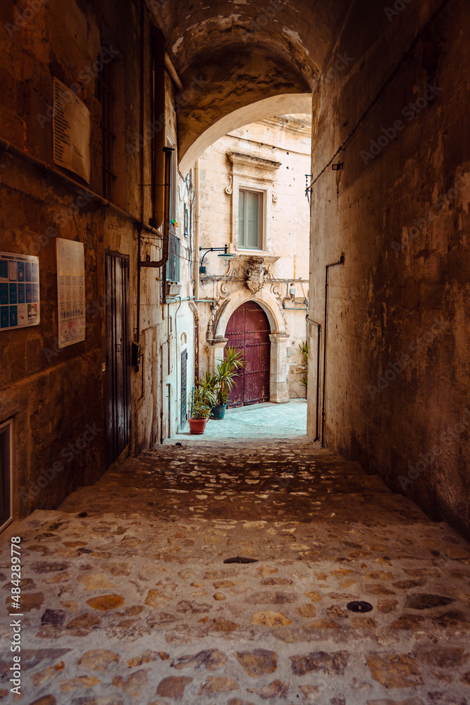 Covered alleyway in the Sassi of Matera, vertical