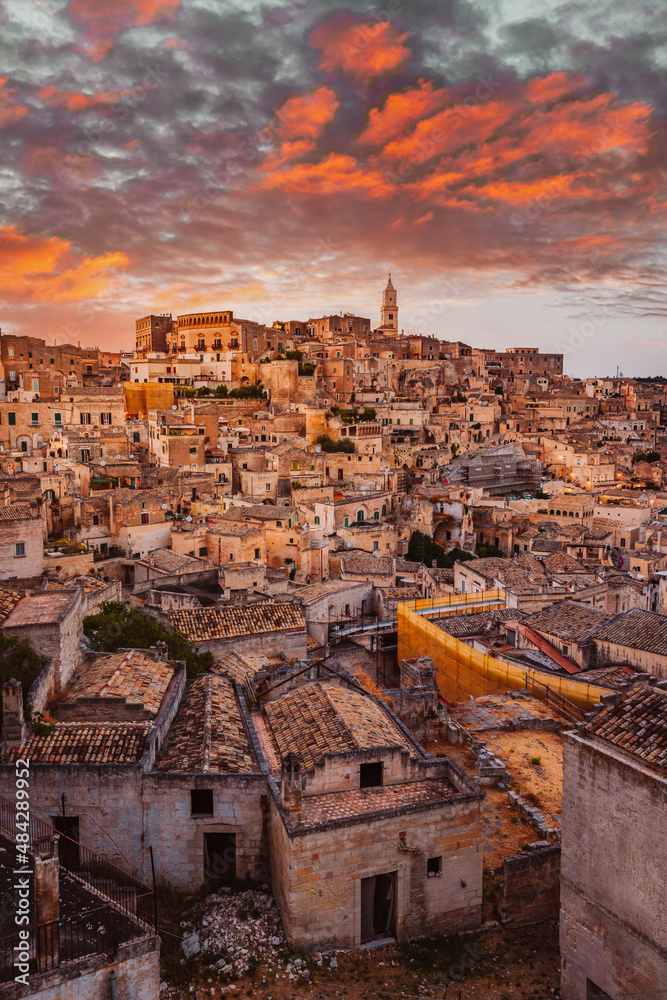 Wide view of Piazzetta Pascoli, Belvedere of Matera on the Sasso Caveoso, at sunset with a spectacular sky, vertical