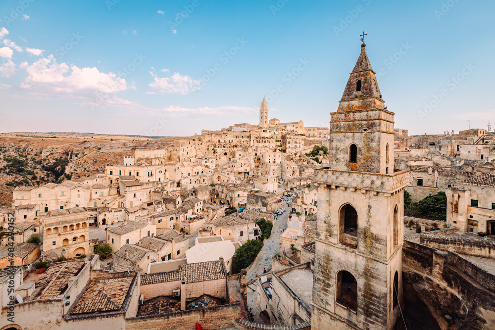Wide view of the Sassi di Matera from the Belvedere di San Pietro Barisano, blue sky with clouds