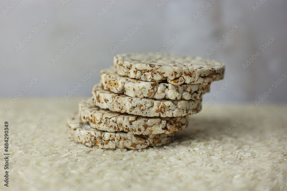 Rice buckwheat cake on a background of strewn rice groats Rice buckwheat cake on a background of strewn rice groats