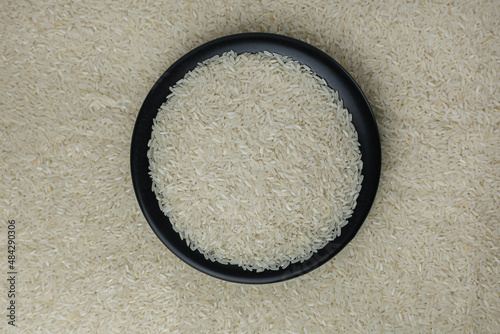 White rice on a black plate in the background around the strewn rice