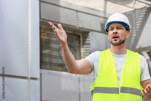 Male builder with ear plugs...