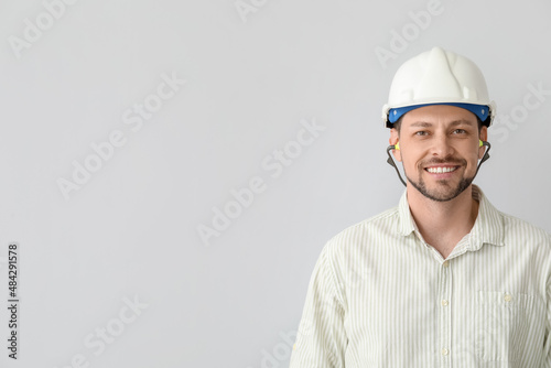 Handsome man in hardhat wit...